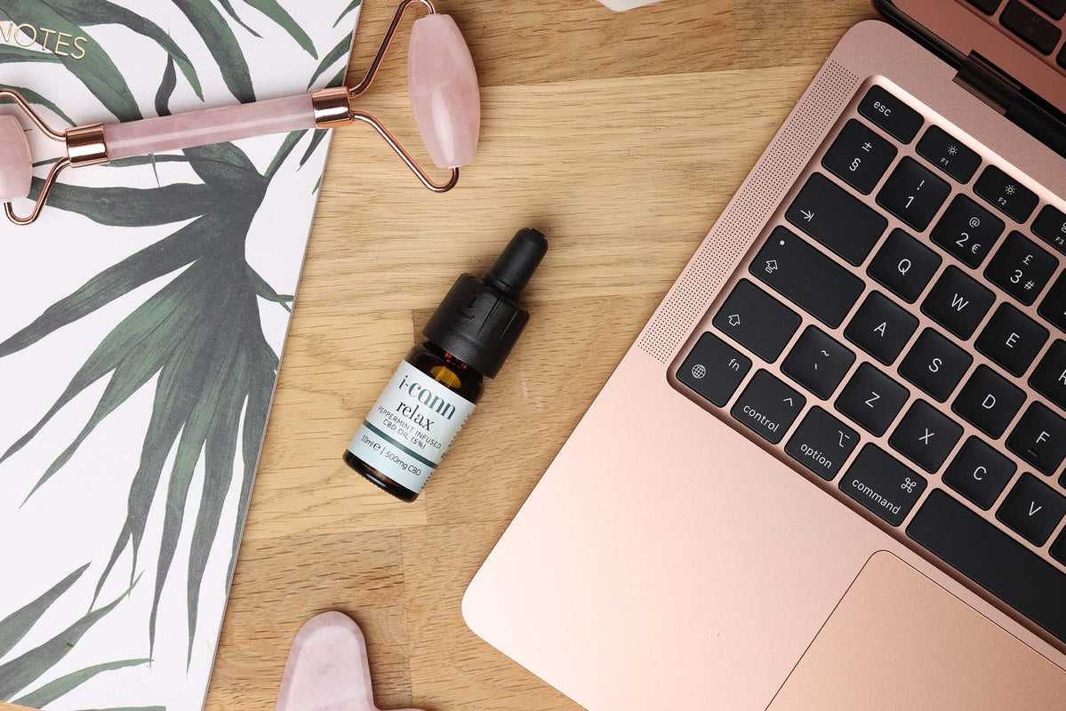 i-Cann product range at someone's workstation to show that CBD can help to ease stress and focus the mind